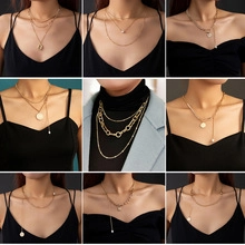 Collection of layered gold necklaces with coin pendants and pearls shown in a grid view