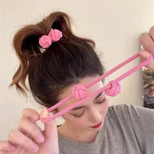 Macro view of high elastic pink hair ties with knotted design shown in use on ponytail