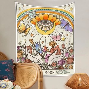 Detail of Moon tarot tapestry with butterflies and roses in a bohemian room setting