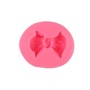 Pink silicone bow mold for fondant cakes and DIY craft projects on white background
