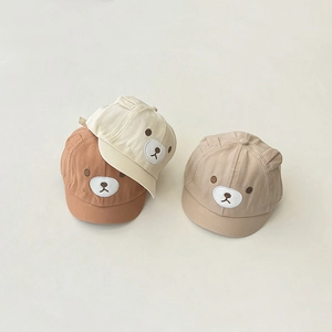 Close-up of cotton baby baseball caps with cute bear ears and detailed embroidery