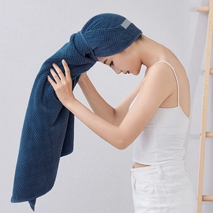 Model wearing dark blue waffle weave microfiber hair towel wrap for quick drying hair