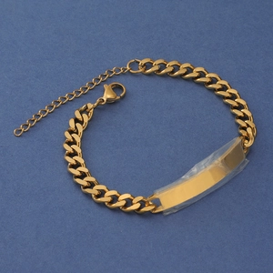 Detailed macro view of gold-plated stainless steel Cuban link bracelet with lobster clasp