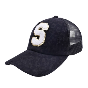 Close-up of distressed black trucker hat with towel embroidery S and gold sequins