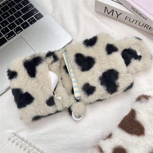 Macro shot of plush heart pattern pouch with zipper and plastic clip for earbuds