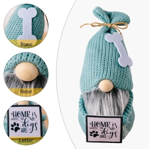 Detail view of teal dog gnome featuring bone decoration, wooden nose and letter sign