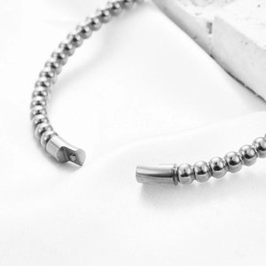 Macro view of 5MM stainless steel bead bracelet with focus on the clasp and texture