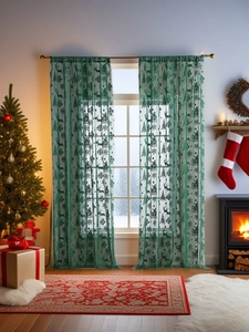 Détail de rideaux de Noël en dentelle verte avec motifs de rennes et d'arbres pour maison