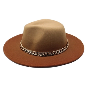 Detail of camel wool fedora hat featuring a contrasting brim and bold gold chain decoration