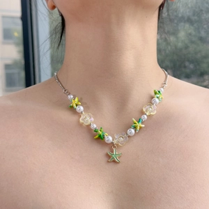 Close-up of beach necklace with colorful starfish, flower beads and white pearls