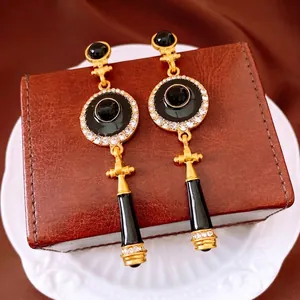 Vintage style black and gold drop earrings with sparkling rhinestones for a luxury look