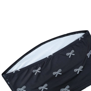 Detailed view of the bow-knot print on the black bandeau top with a white inner lining