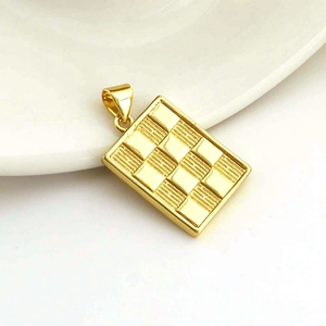 Macro view of a 18k gold plated rectangular pendant featuring a checkered pattern