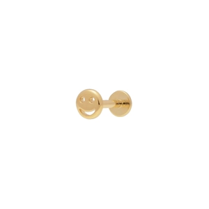 Detail of a polished golden smiley face labret stud earring with a flat back design