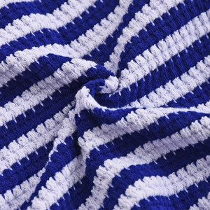 Detailed close-up of blue and white striped knit texture with intricate crochet craftsmanship