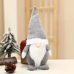 Detail of gray sequined knit hat and long faux fur beard on a Christmas gnome doll
