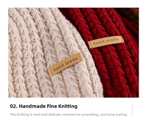 Detailed macro view of heavy knit scarves with ribbed texture and handmade leather labels