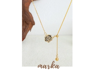 Macro view of rose flower pendant with cubic zirconia and adjustable gold chain