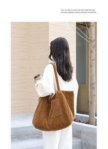 Close-up of brown corduroy shoulder bag with front pocket shown in lifestyle setting