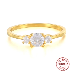 Detailed macro of gold plated 925 sterling silver ring with three sparkling round stones