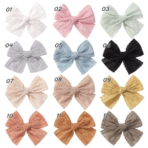 Detailed grid view of hollow lace bow hair clips in 12 assorted colors for girls