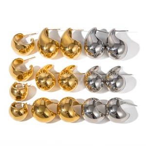 Polished hollow drop and hoop earrings set in gold and silver finish on white background