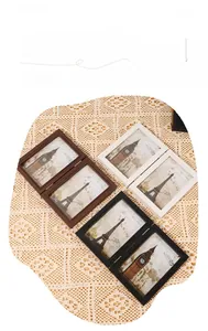 Close-up of folding double photo frames in dark brown, white, and black wood finishes