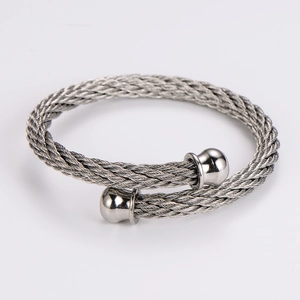 Detail of silver stainless steel twisted wire cuff bracelet with polished bead ends
