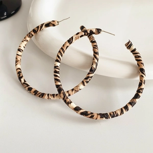 Detailed view of large leopard print hoop earrings with textured fabric wrap finish