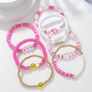 Pink and white bohemian beaded bracelet set with smiley face and heart charms