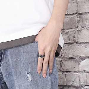 Close-up of rotatable punk skull ring in silver and black finish on male finger
