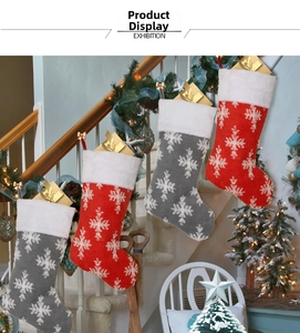 Plush Christmas stockings with white snowflake patterns hanging on stairs decoration