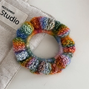 Detailed close-up of rainbow crochet hair ring showing 3D bubble stitch texture