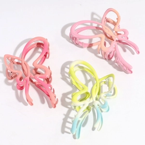 Detailed view of three gradient butterfly hair claws in pink, orange, and blue matte finish