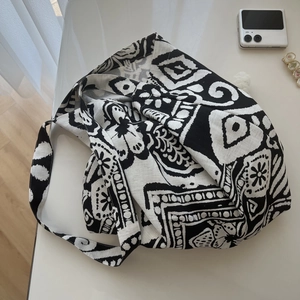 Detail of bohemian tote bag with black and white geometric ethnic patterns on cotton linen