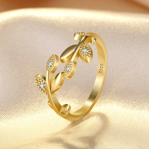 Macro shot of S925 sterling silver golden leaf ring with white zircon crystal details
