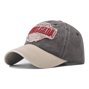Close-up of vintage washed baseball cap with cow embroidery and retro distressed texture