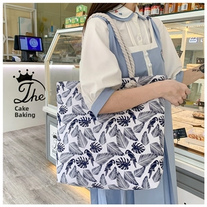 Fashionable floral canvas tote bag with thick rope handles and monstera leaf print