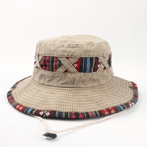 Detail of beige cotton bucket hat featuring ethnic embroidery and adjustable wind rope