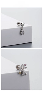 Detail of silver titanium heart and floral stud earrings with cubic zirconia and pearls