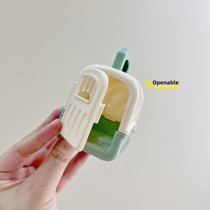 Detail showing the openable side door of the mint green and cream toy pet carrier box
