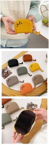 Detail of cute cat-shaped card holder with multi-slot accordion style and cat tail zipper