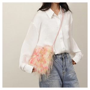 Detail of pink and yellow gradient faux fur bag worn as a shoulder bag on model