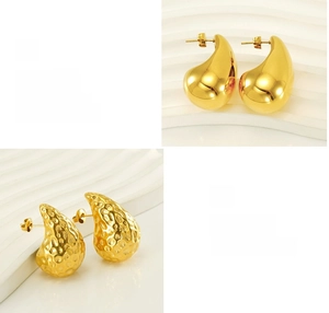 Detailed view of 18K gold drop earrings with polished finish and hammered texture designs