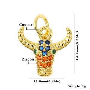 Detailed view of a gold bull head pendant made of copper with colorful zircon stones