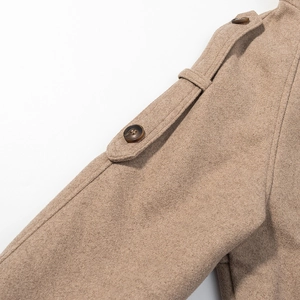 Close-up of khaki wool blend coat showing shoulder epaulets and decorative button details