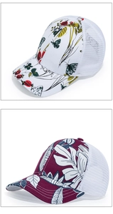 Detail of floral butterfly and tropical leaf prints on breathable mesh baseball caps