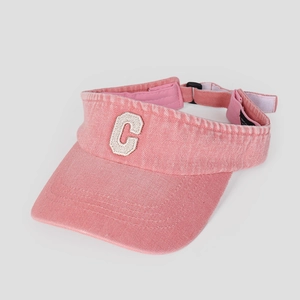 Detailed view of the pink sun visor hat with a varsity embroidered C letter patch