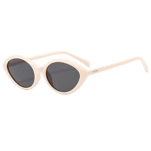 Retro oval cat-eye sunglasses in cream white with black lenses and metal rivet accents