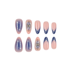 Starry sky press-on nails with blue and pink gradient and golden sun charms